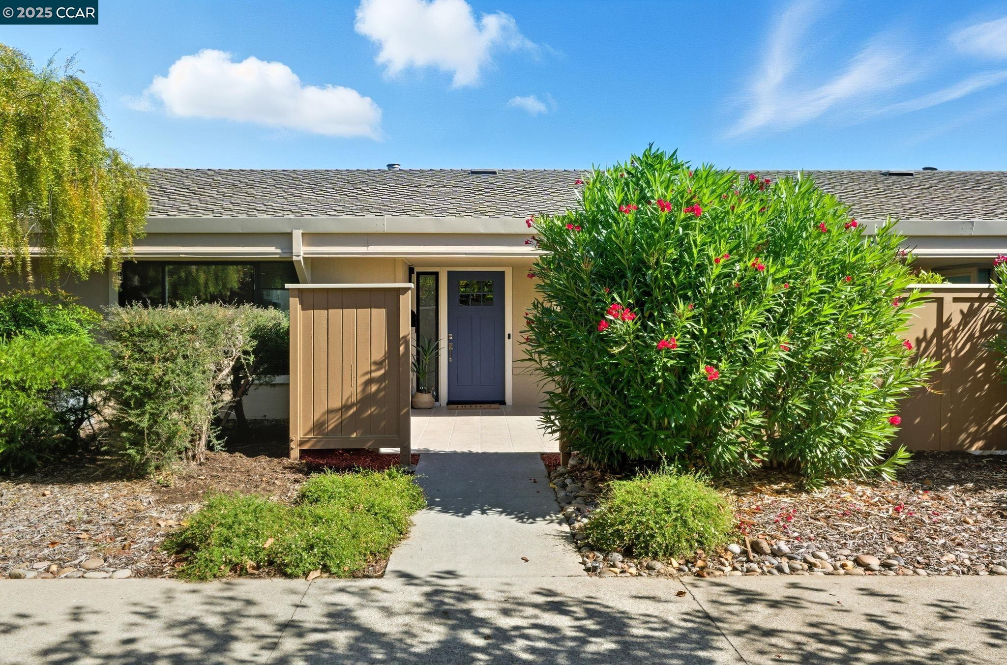 2132 Golden Rain Road, Unit 2 Walnut Creek, CA 94595 - Photo 29 of 38 a front view of a house with a yard