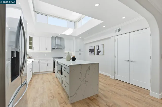 a kitchen with cabinets and wooden floor