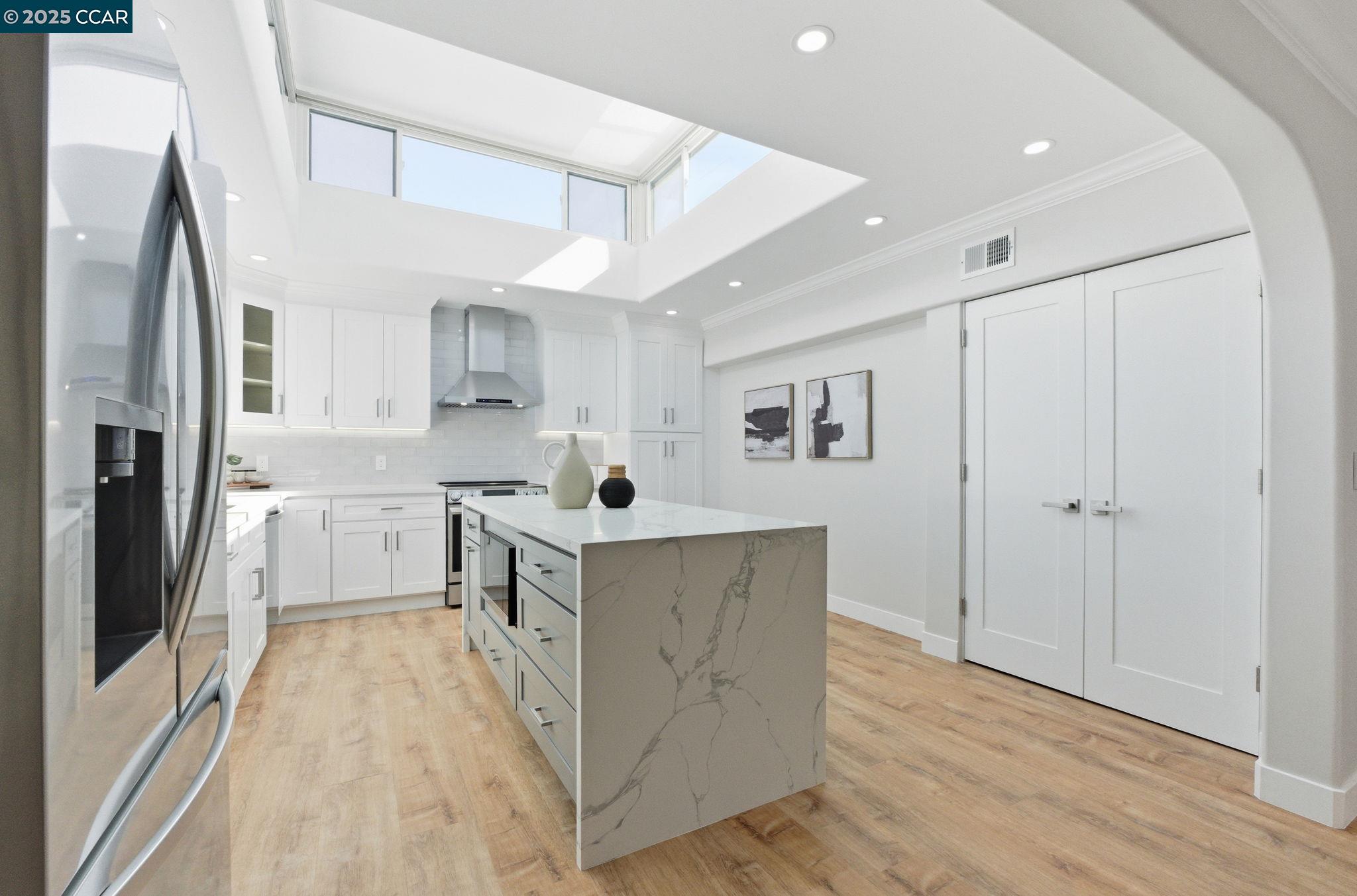 2132 Golden Rain Road, Unit 2 Walnut Creek, CA 94595 - Photo 3 of 38 a kitchen with cabinets and wooden floor