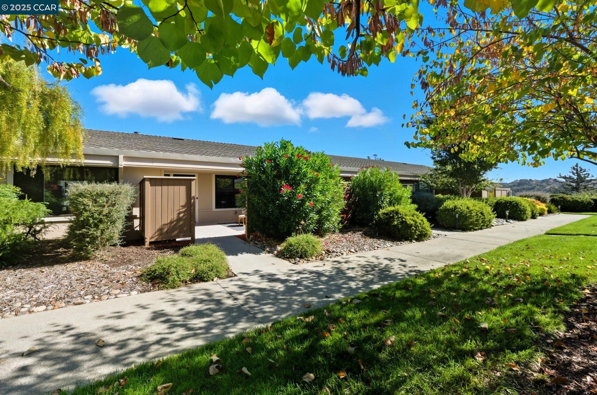 2132 Golden Rain Road, Unit 2 Walnut Creek, CA 94595 - Photo 31 of 38 a view of a house with a tree and garden