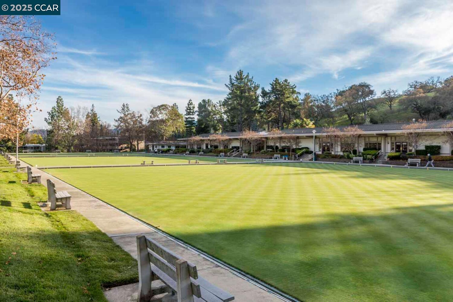 2132 Golden Rain Road, Unit 2 Walnut Creek, CA 94595 - Photo 33 of 38 a view of a swimming pool with lawn chairs and large trees