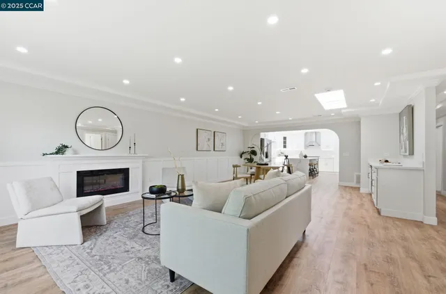 a living room with furniture a fireplace and a potted plant