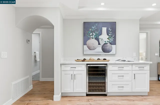 a kitchen with a stove and a wooden floor