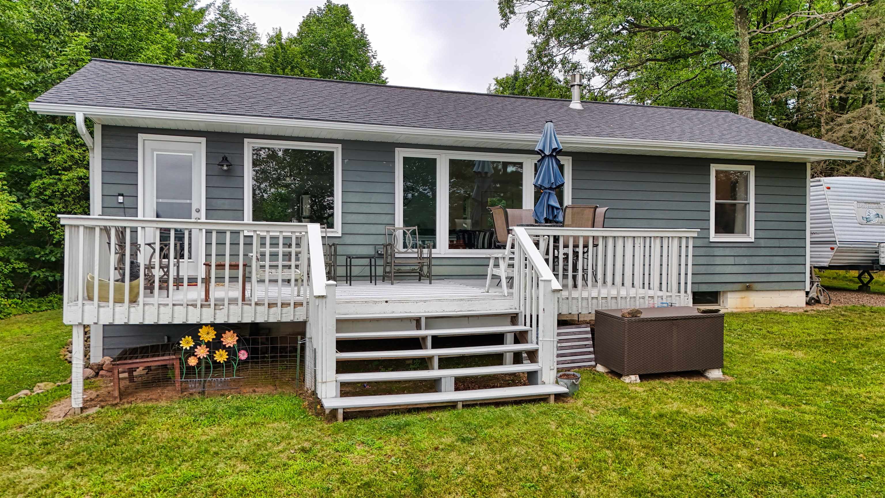 7144 Malm Road Winter, WI 54896 - Photo 1 of 58 Back of property featuring a deck, a shingled roof, a yard, and stairway