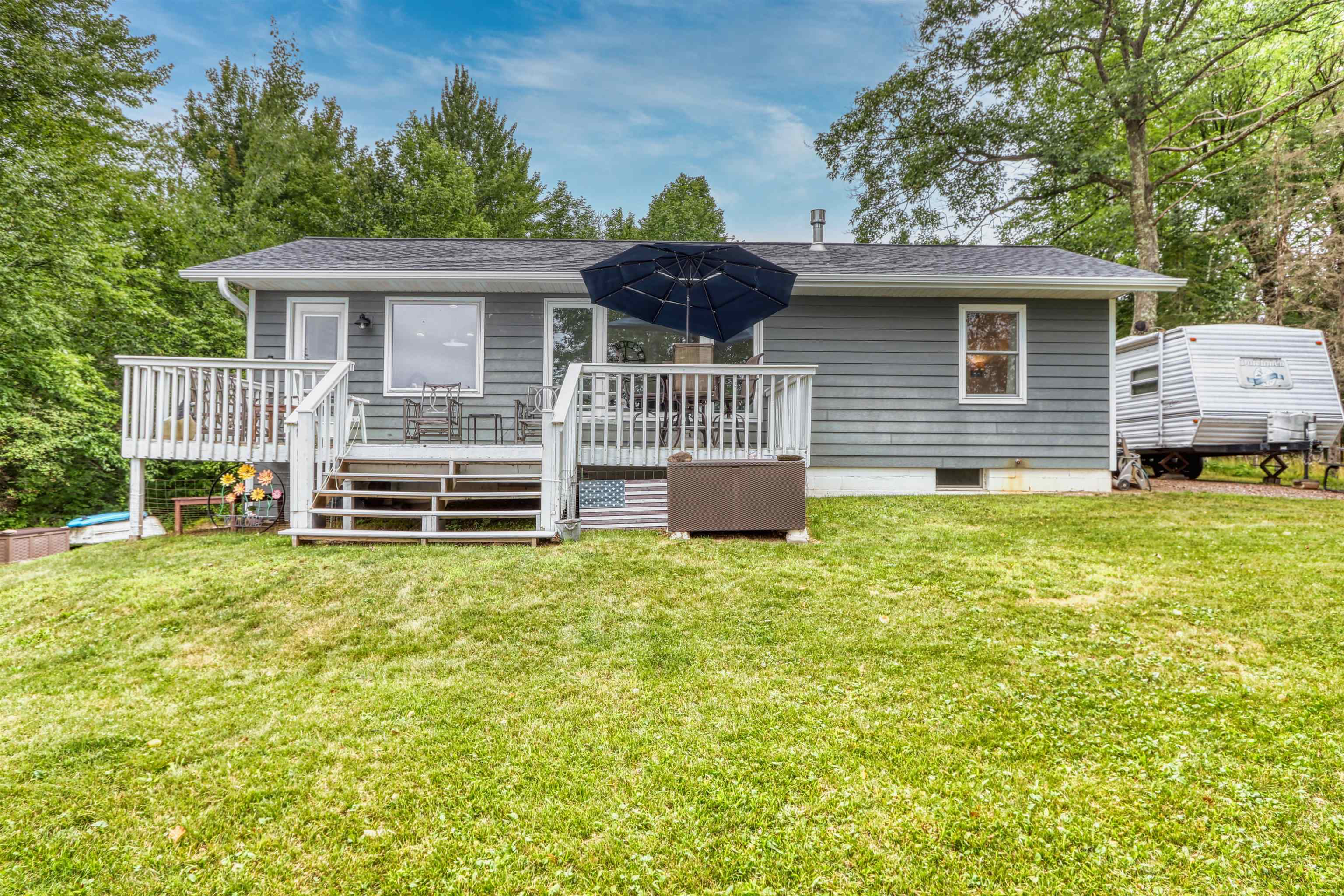 7144 Malm Road Winter, WI 54896 - Photo 11 of 58 Rear view of property with a wooden deck, a lawn, and roof with shingles