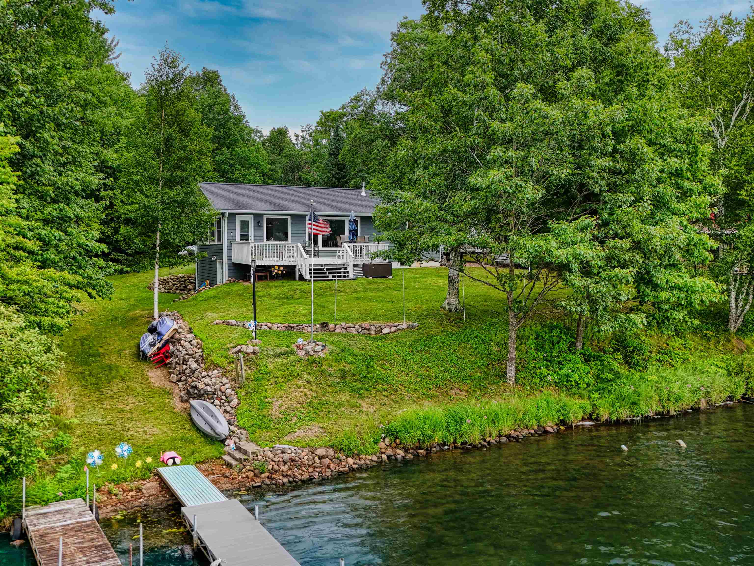 7144 Malm Road Winter, WI 54896 - Photo 2 of 58 Rear view of property with a deck with water view and a lawn