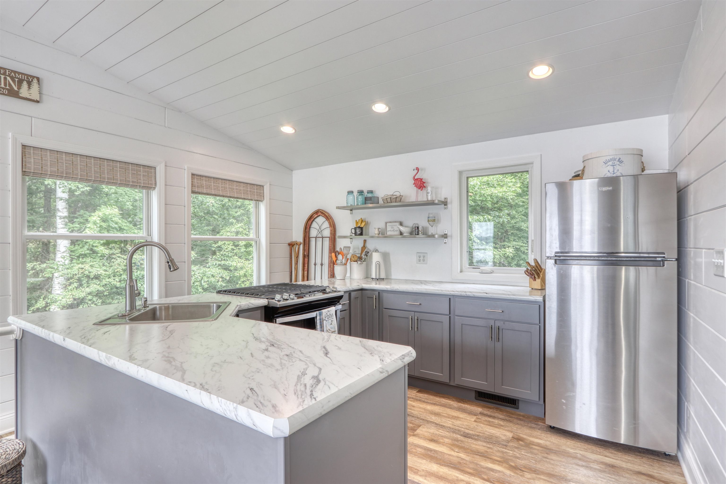 7144 Malm Road Winter, WI 54896 - Photo 21 of 58 Kitchen featuring gray cabinetry, stainless steel appliances, vaulted ceiling, light wood-style floors, and recessed lighting