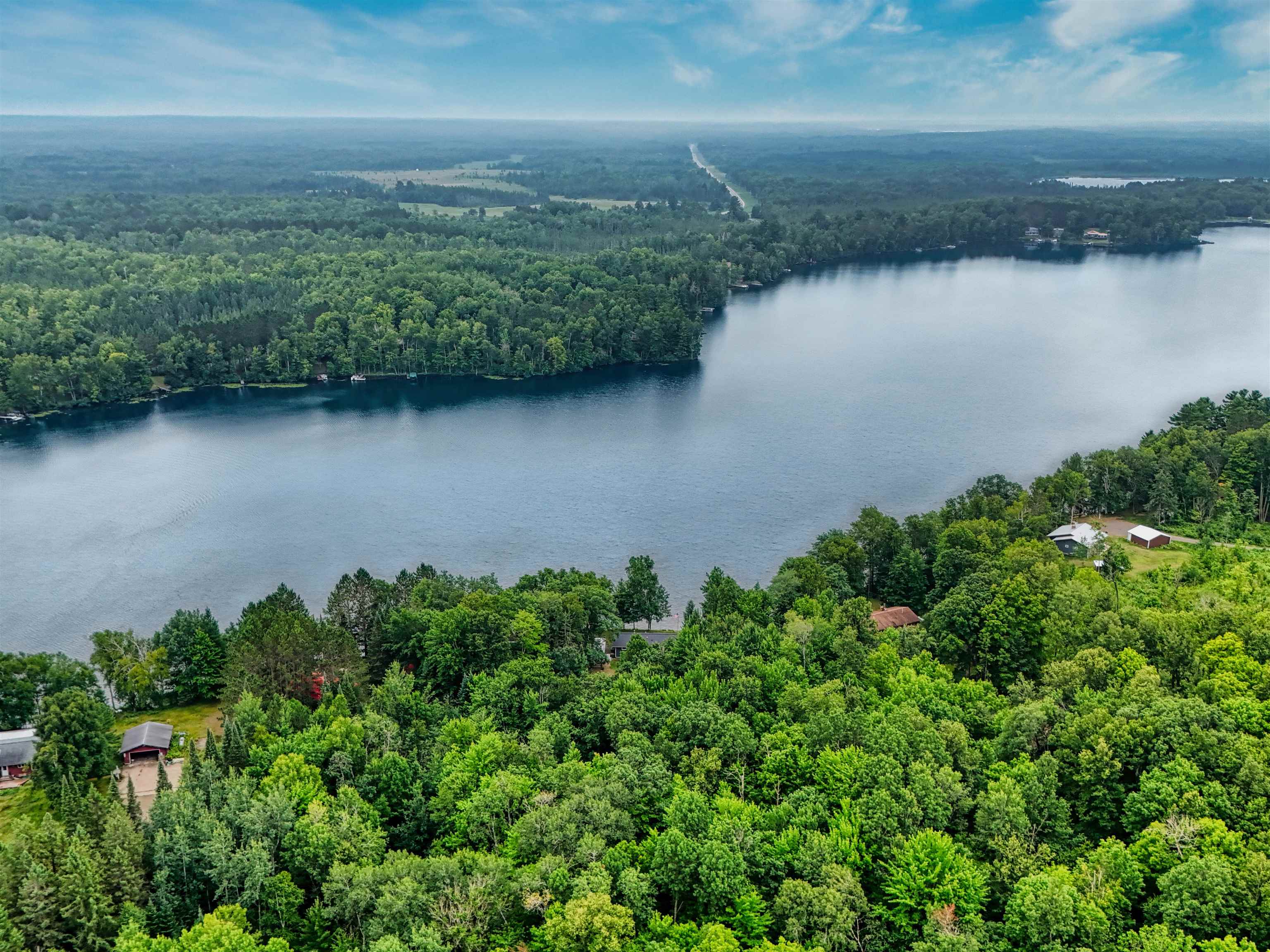 7144 Malm Road Winter, WI 54896 - Photo 6 of 58 Bird's eye view of a heavily wooded area and a large body of water
