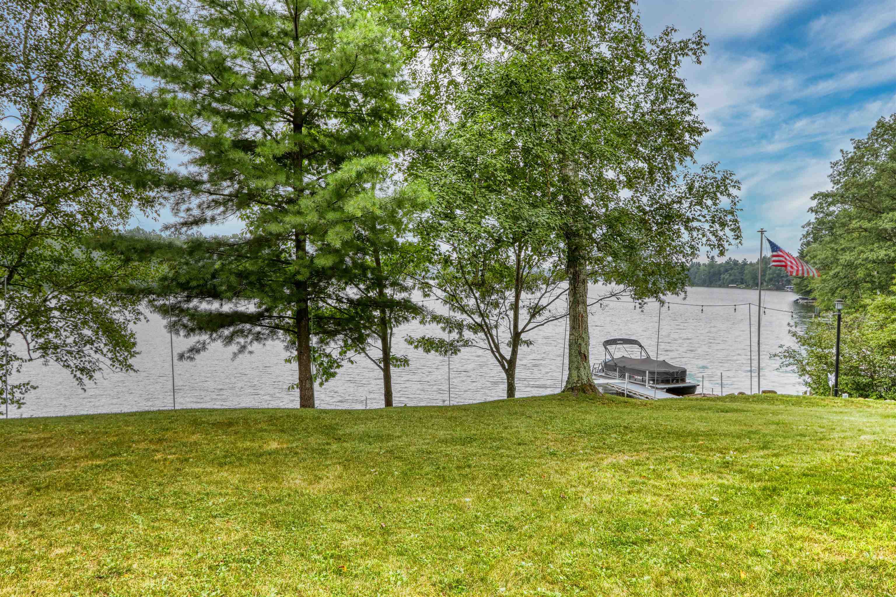 7144 Malm Road Winter, WI 54896 - Photo 9 of 58 View of green lawn featuring a water view and a boat dock