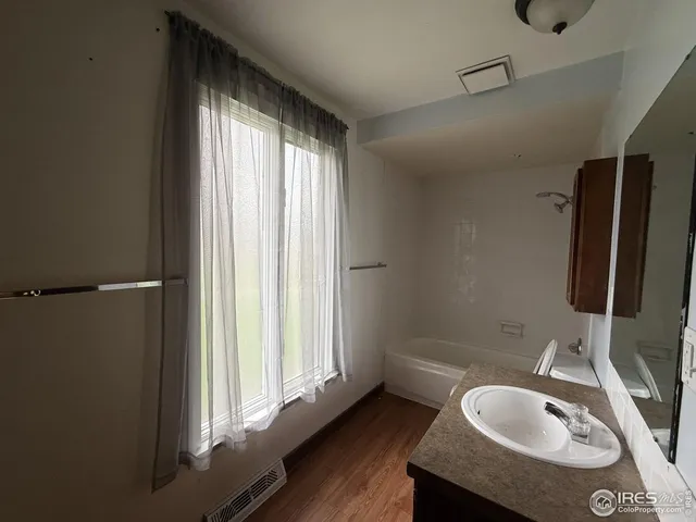 a bathroom with a sink a toilet and tub