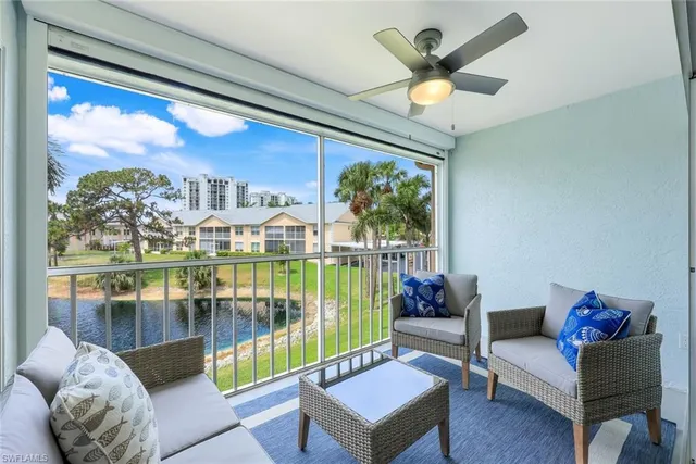 a living room with furniture a window and a flat screen tv