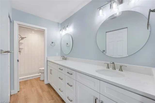 a bedroom with a large bed and a flat screen tv