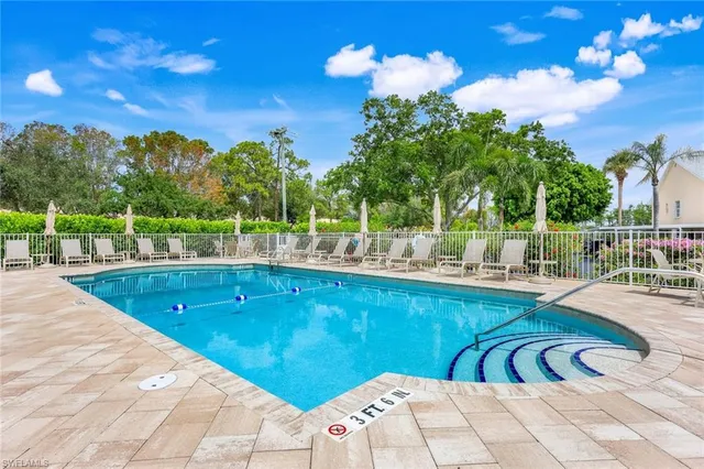 a view of a swimming pool with a lounge chair