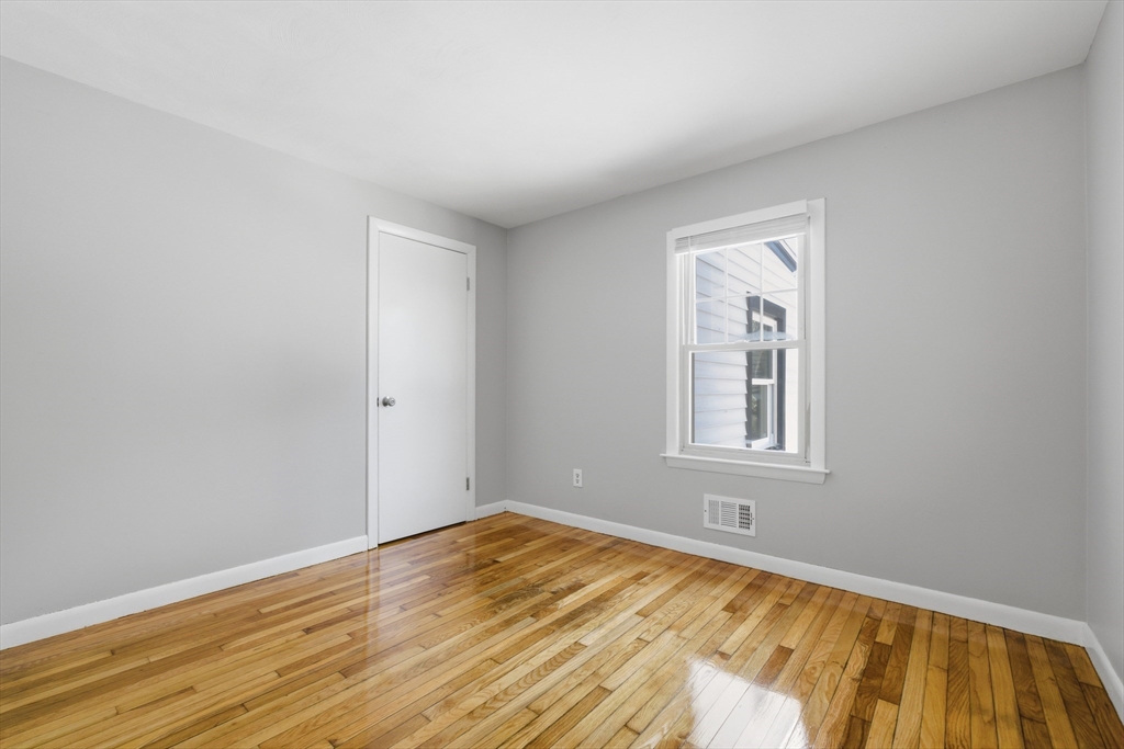 4 Smith Street Attleboro, MA 02703 - Photo 12 of 20 a view of an empty room with wooden floor and a window