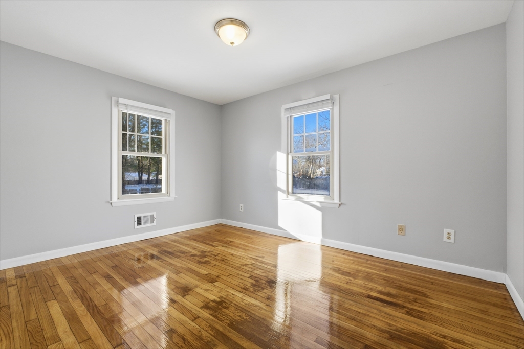 4 Smith Street Attleboro, MA 02703 - Photo 15 of 20 a view of an empty room with wooden floor and a window