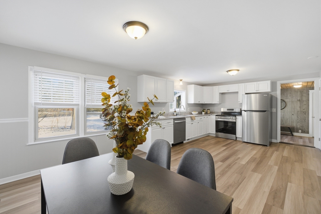 4 Smith Street Attleboro, MA 02703 - Photo 6 of 20 a kitchen with white cabinets and stainless steel appliances