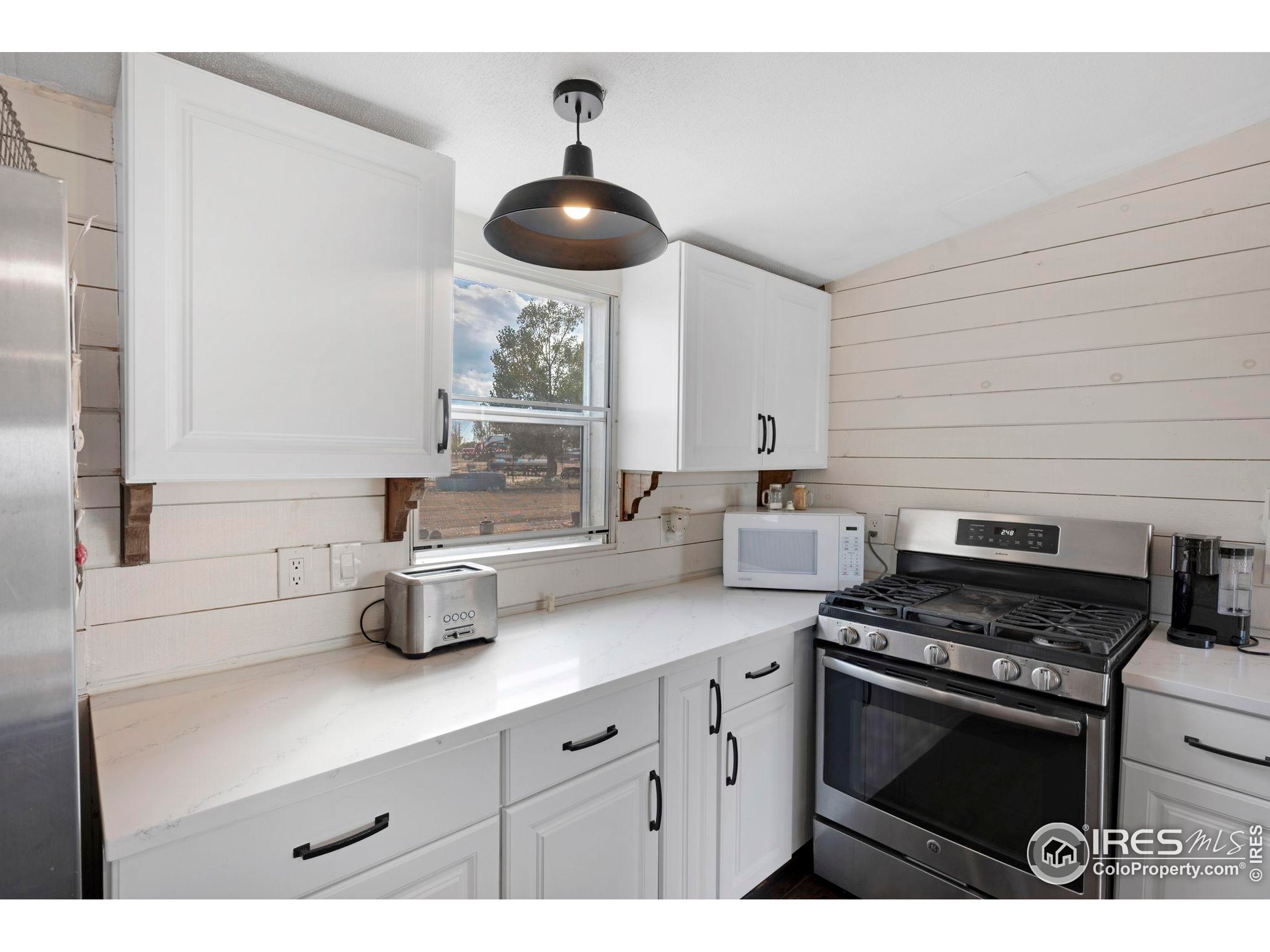9875 County Road 24 Fort Lupton, CO 80621 - Photo 29 of 50 a kitchen with a stove and a sink