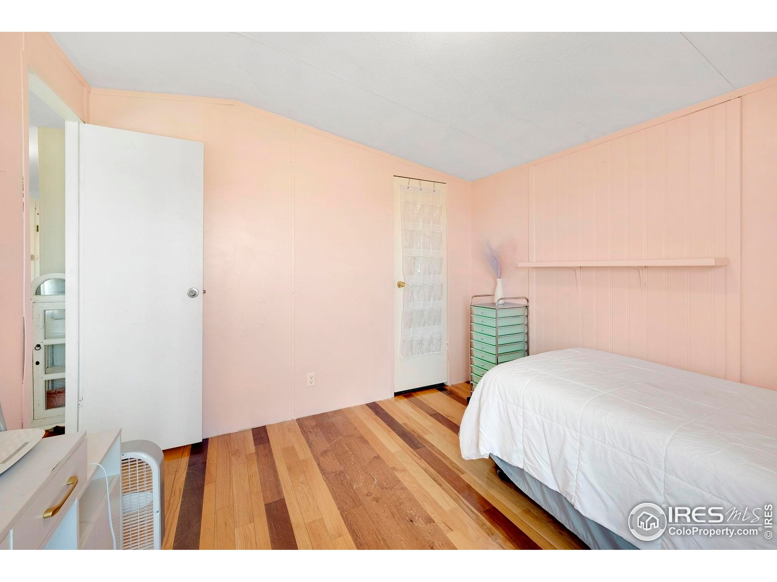 9875 County Road 24 Fort Lupton, CO 80621 - Photo 40 of 50 a bedroom with a bed and a night stand