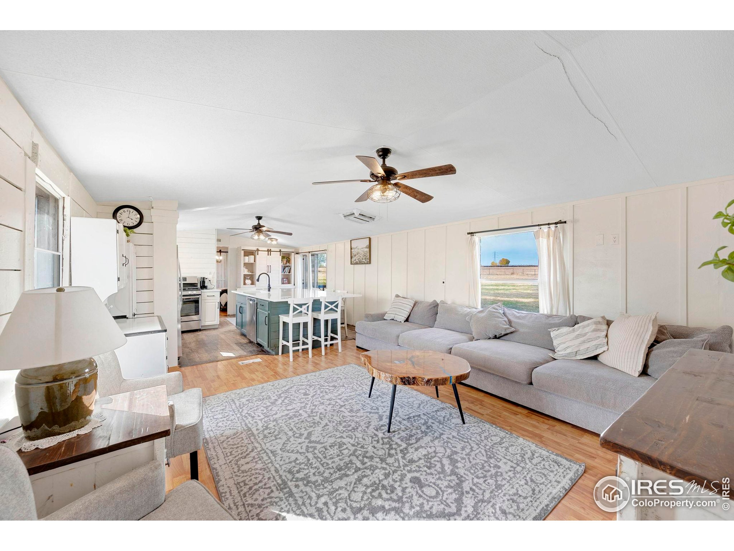 9875 County Road 24 Fort Lupton, CO 80621 - Photo 45 of 50 a living room with furniture and a large window