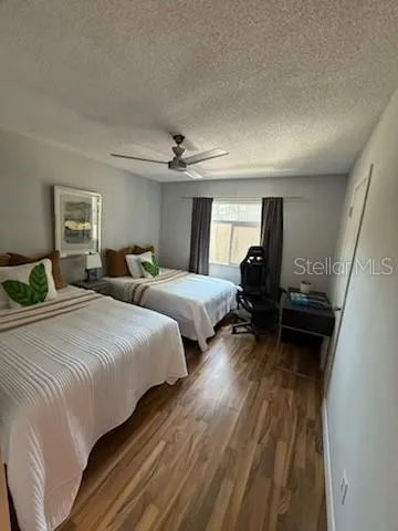 a bedroom with two beds and a couch