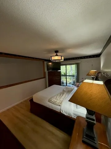 a bed sitting in a bedroom next to a window