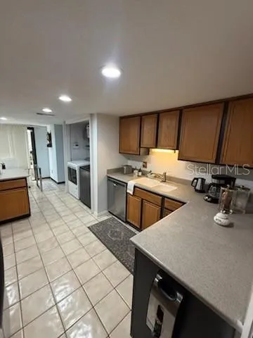 a kitchen with stainless steel appliances a sink a stove top oven a counter space and cabinets