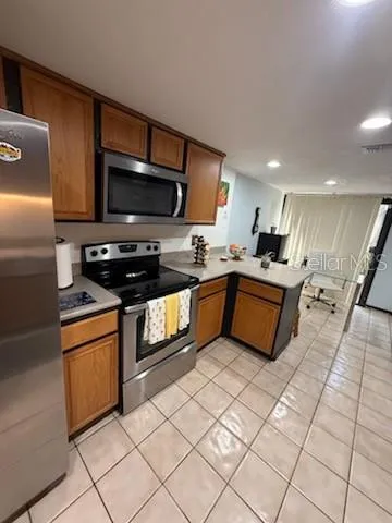 a kitchen with stainless steel appliances granite countertop a sink dishwasher stove top oven and cabinets