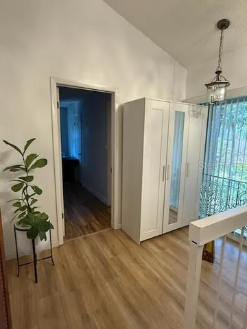 a view of a hallway to a livingroom with furniture