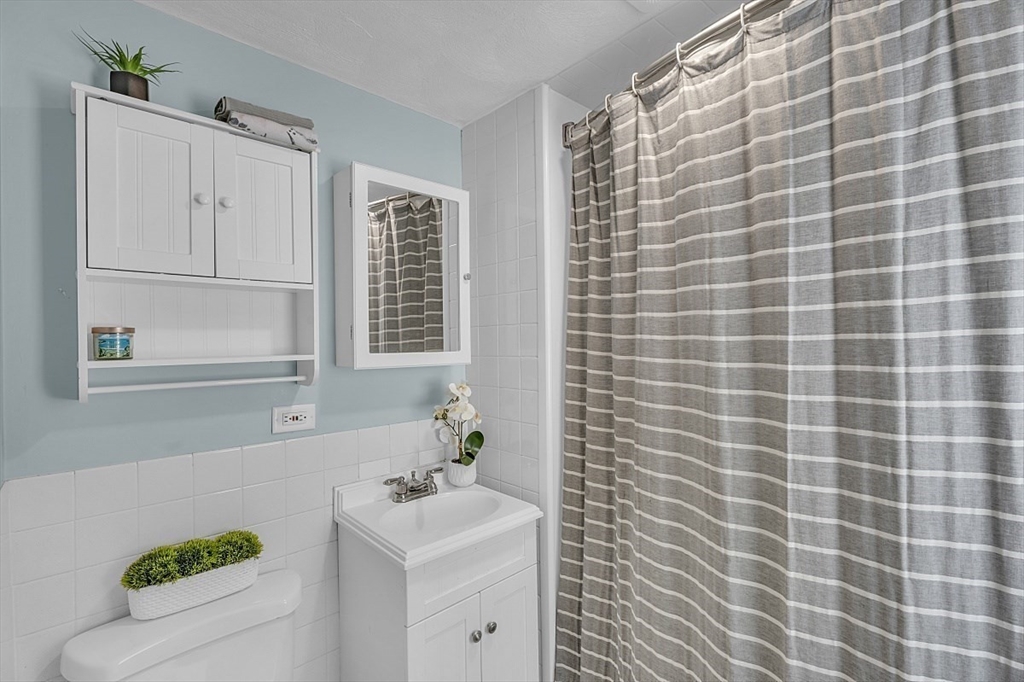 898 Boston Road Billerica, MA 01821 - Photo 12 of 38 a bathroom with a sink a toilet and shower