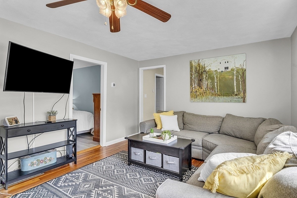 898 Boston Road Billerica, MA 01821 - Photo 22 of 38 a living room with furniture and a flat screen tv
