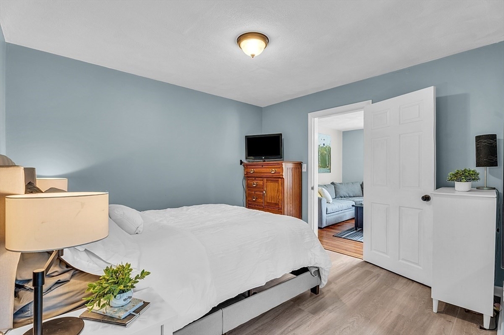 898 Boston Road Billerica, MA 01821 - Photo 23 of 38 a bedroom with a bed and a flat screen tv