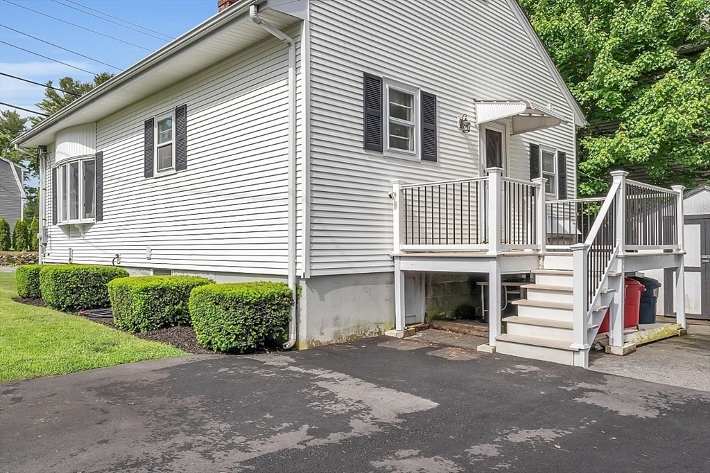 898 Boston Road Billerica, MA 01821 - Photo 29 of 38 a front view of a house with a yard and potted plants