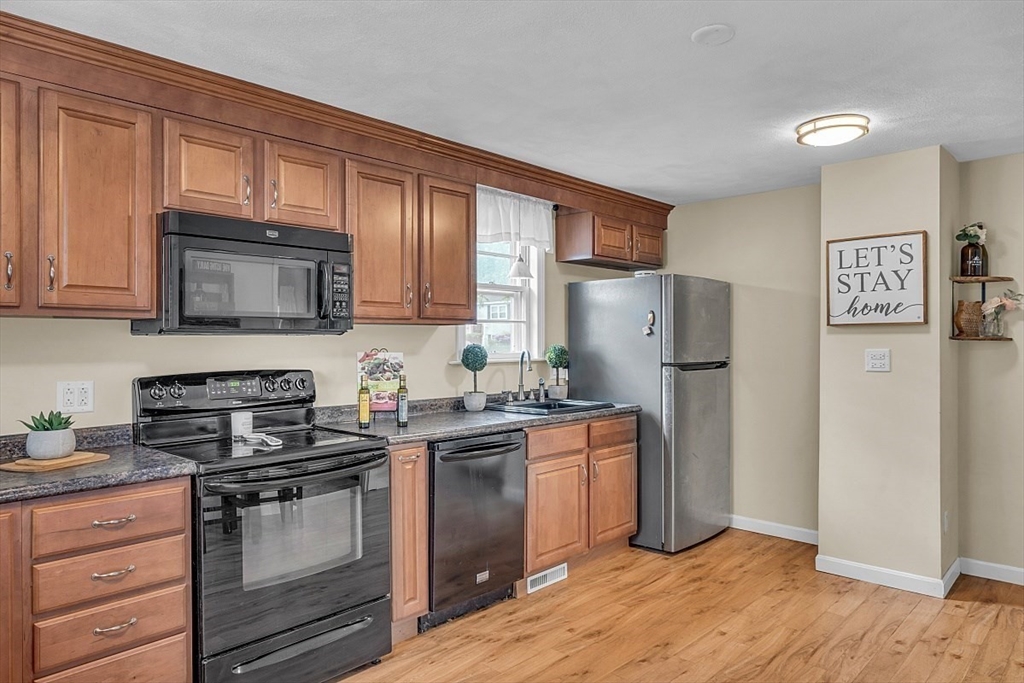 898 Boston Road Billerica, MA 01821 - Photo 5 of 38 a kitchen with stainless steel appliances granite countertop a refrigerator stove microwave and sink