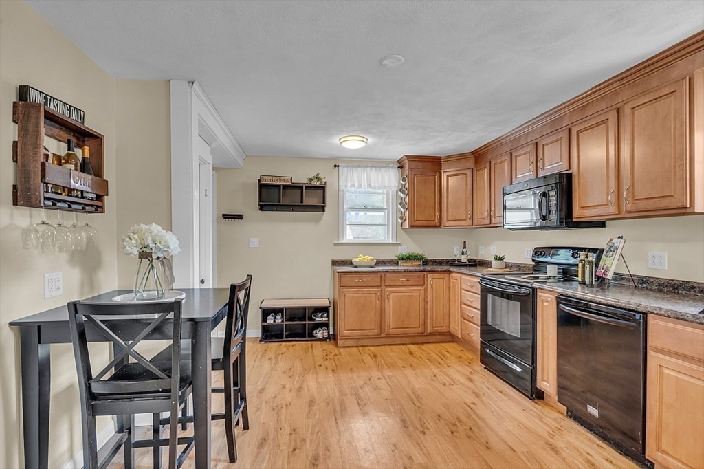 898 Boston Road Billerica, MA 01821 - Photo 6 of 38 a kitchen with stainless steel appliances granite countertop wooden cabinets a stove top oven a sink and dishwasher
