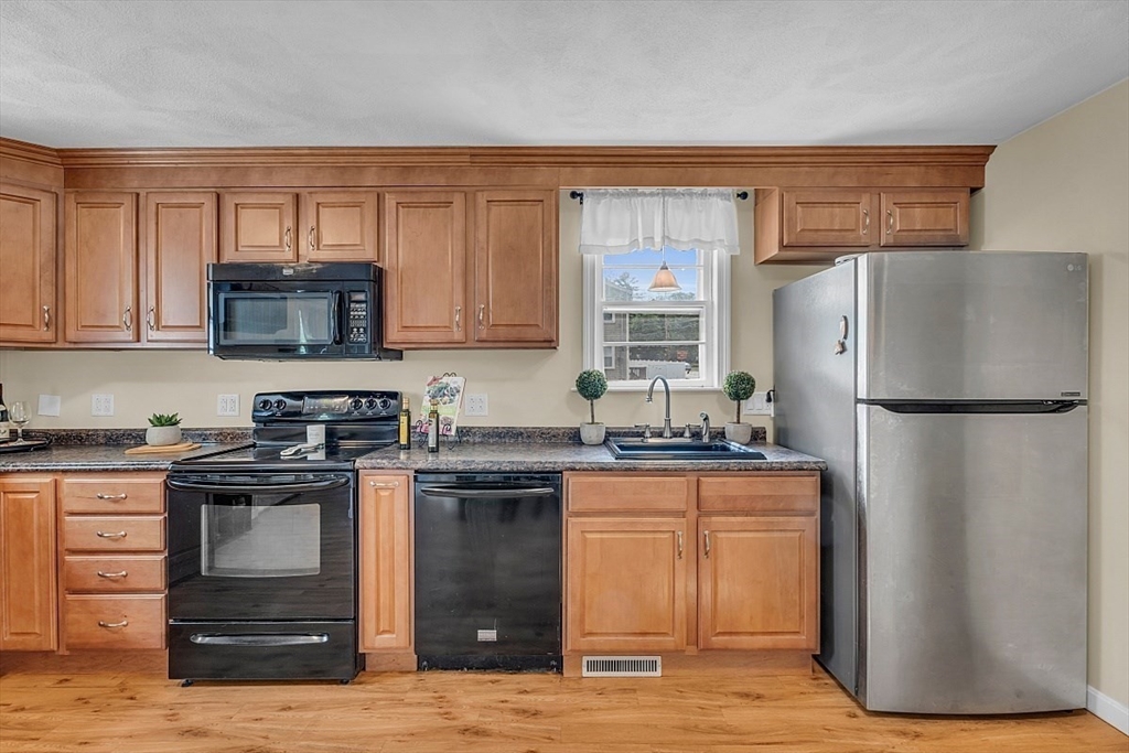 898 Boston Road Billerica, MA 01821 - Photo 7 of 38 a kitchen with a sink stove and refrigerator