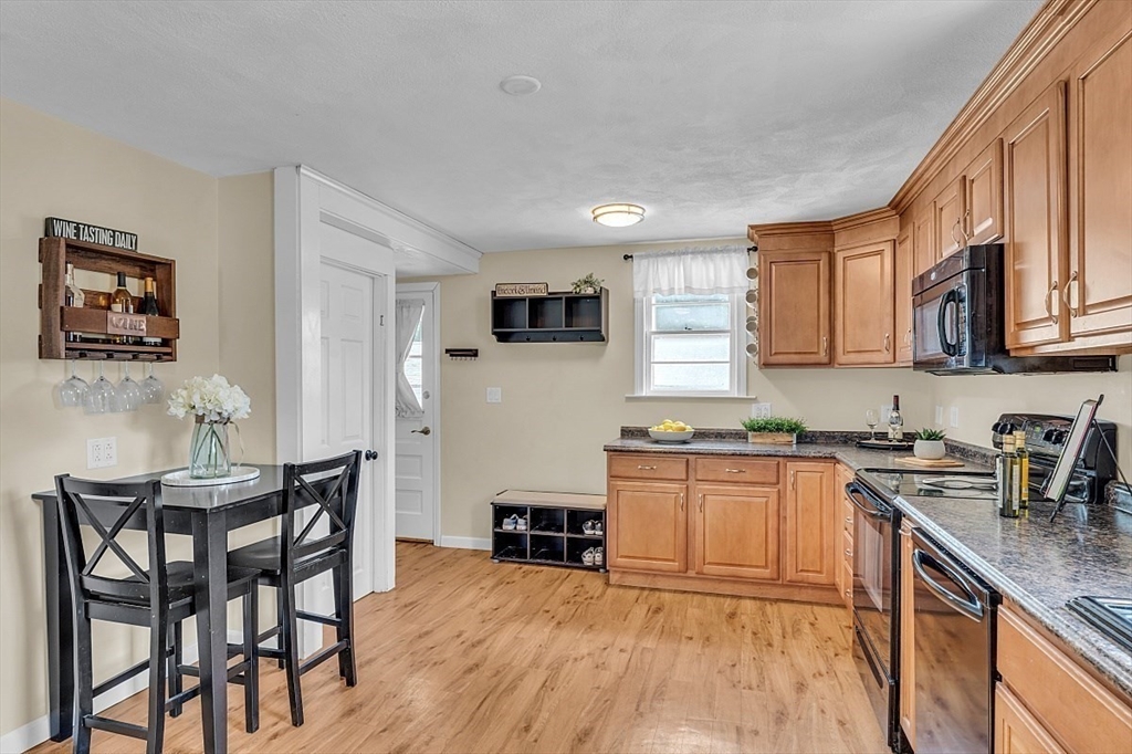 898 Boston Road Billerica, MA 01821 - Photo 9 of 38 a kitchen with granite countertop kitchen island wooden cabinets and stainless steel appliances