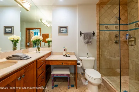 a bedroom with two beds and a large window