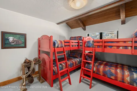 a bathroom with a granite countertop sink a toilet and a shower