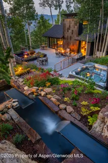 a view of a backyard with a patio and outdoor seating