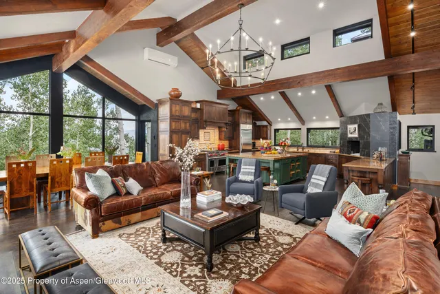 a living room with lots of furniture and a floor to ceiling window