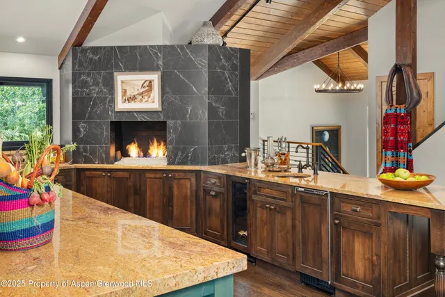 a kitchen with stainless steel appliances granite countertop a sink and a wooden cabinets