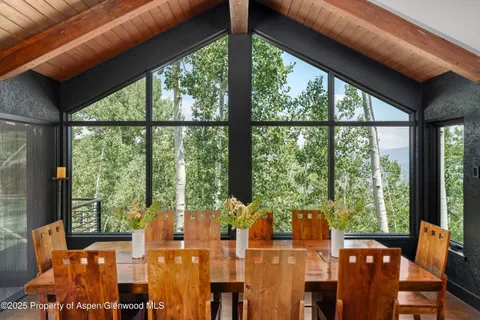 a view of a city from a dining room with large windows