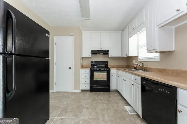 a kitchen with a refrigerator stove and sink