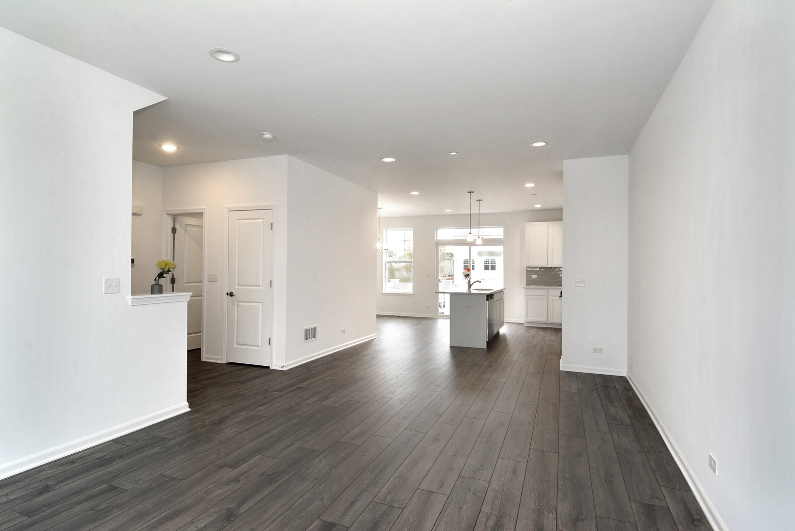 309 Timberleaf Circle Roselle, IL 60172 - Photo 3 of 16 a view of an empty room and a kitchen with wooden floor