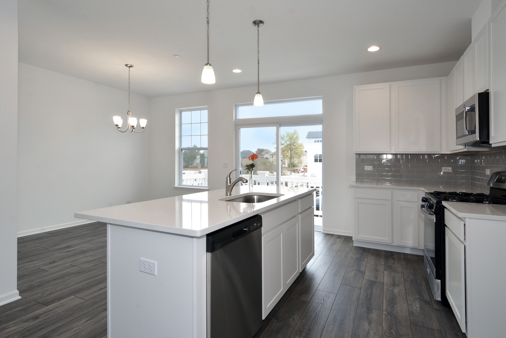 309 Timberleaf Circle Roselle, IL 60172 - Photo 4 of 16 a kitchen with kitchen island granite countertop a sink appliances and cabinets