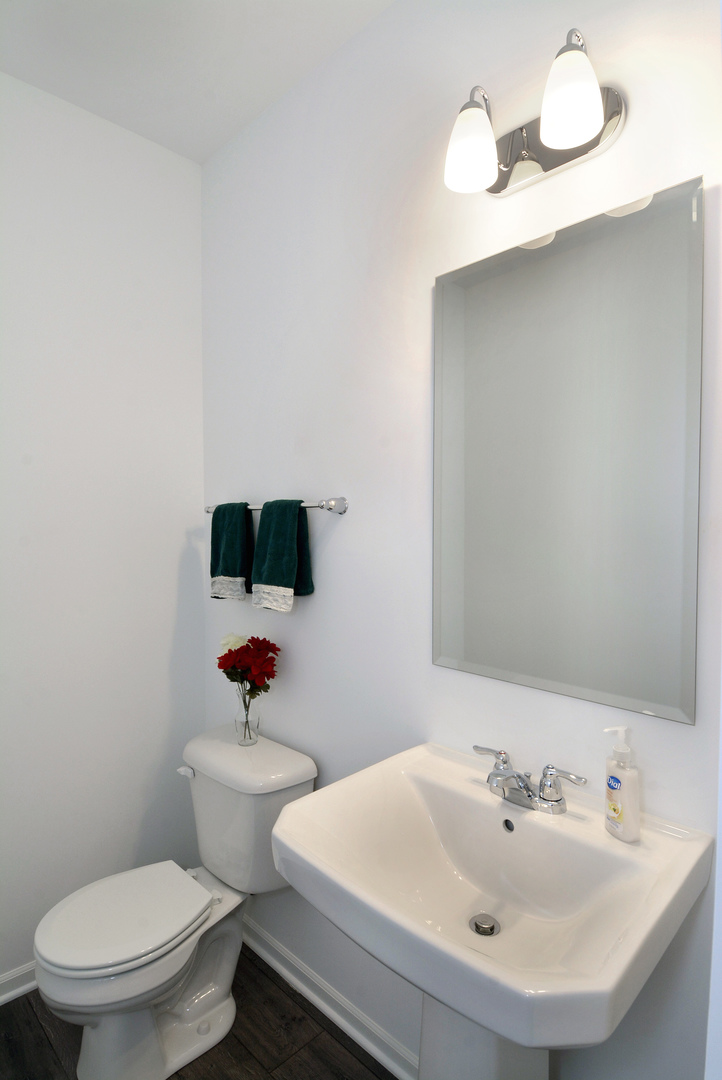 309 Timberleaf Circle Roselle, IL 60172 - Photo 6 of 16 a white toilet sitting next to a bathroom sink