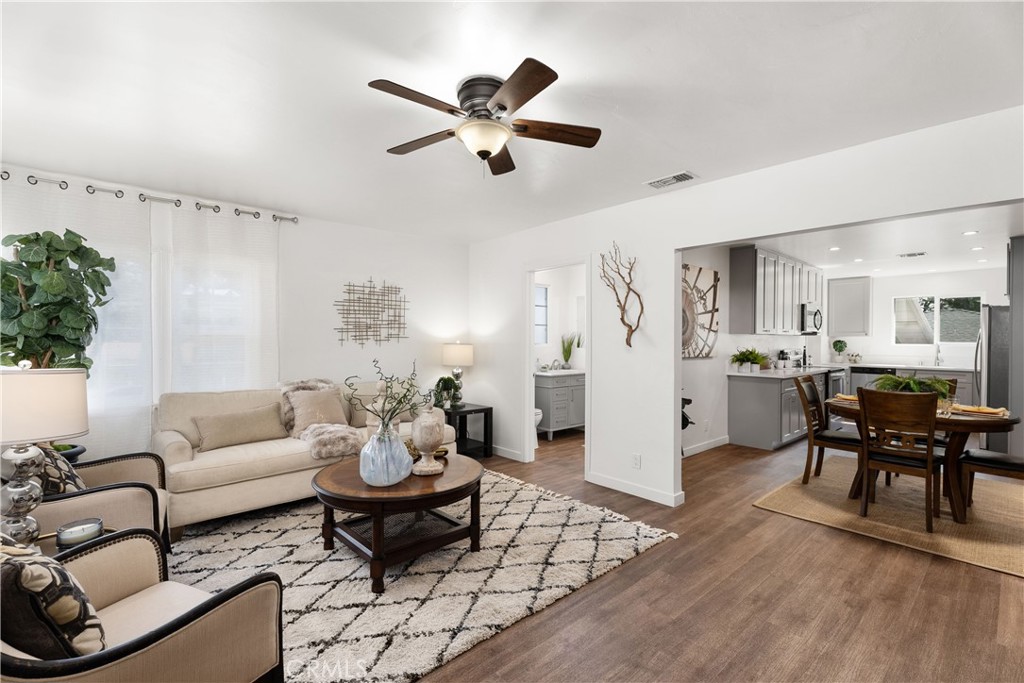 a living room with furniture and kitchen view