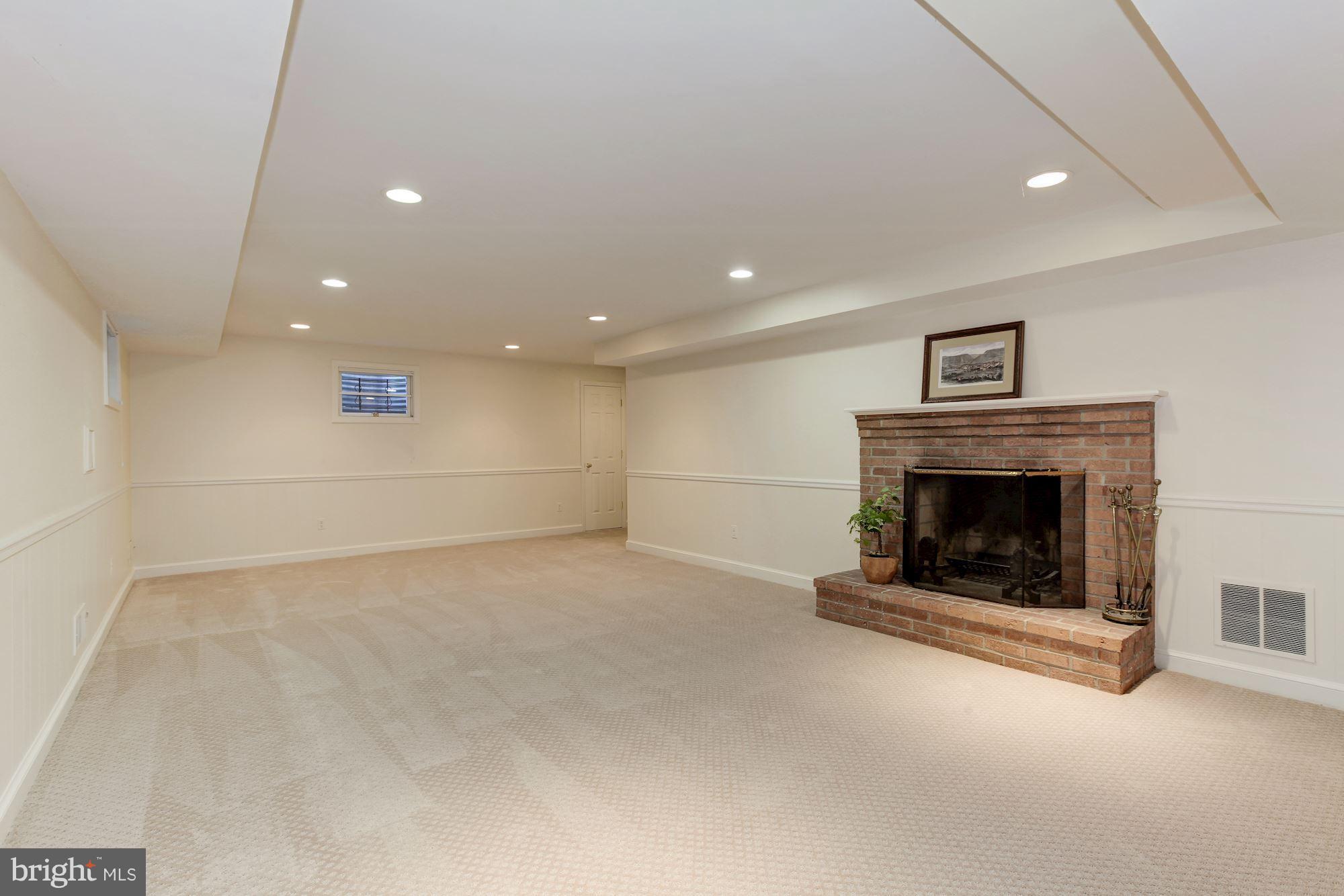 5509 Center Street Chevy Chase, MD 20815 - Photo 22 of 30 a view of an empty room with a fireplace
