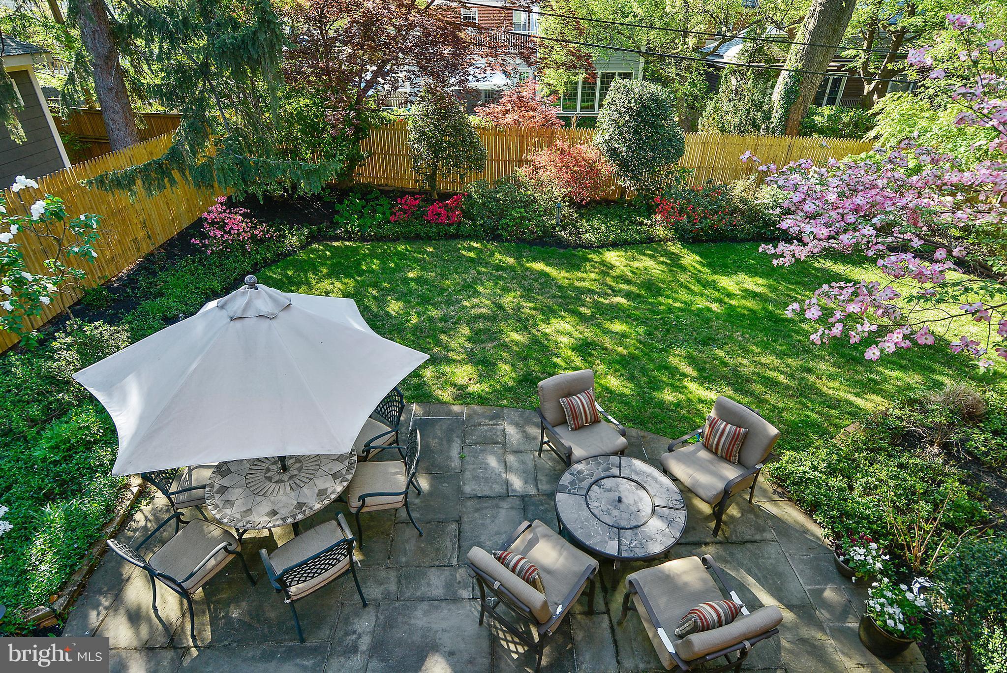 5509 Center Street Chevy Chase, MD 20815 - Photo 28 of 30 a backyard of a house with table and chairs