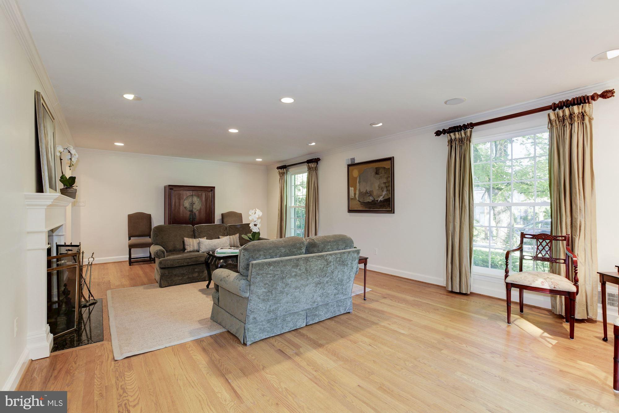 5509 Center Street Chevy Chase, MD 20815 - Photo 4 of 30 a living room with furniture a flat screen tv and a large window